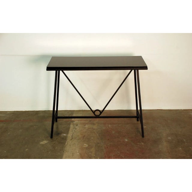 The “Trapeze” Wrought Iron and Lacquer Console.