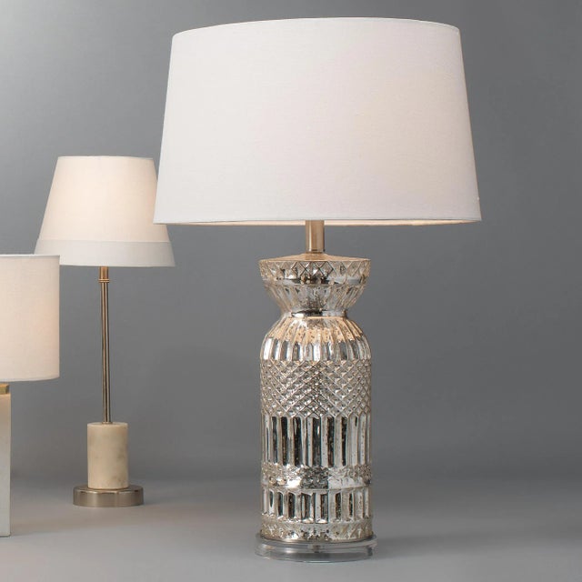 Add a touch of luxury and drama to any room with this accent lamp. Its traditional urn shape is made of mercury glass that...