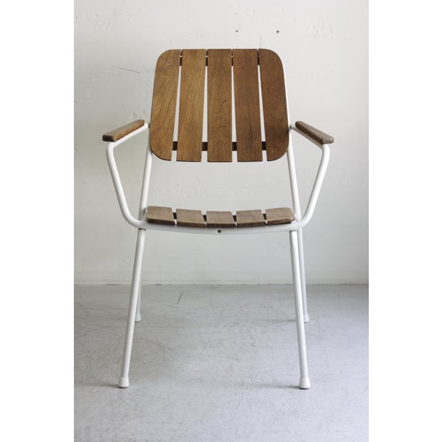 Set of 4 fantastic garden chairs from Daneline White lacquered steel tubing with a teak seat, backrest, and armrests. The...