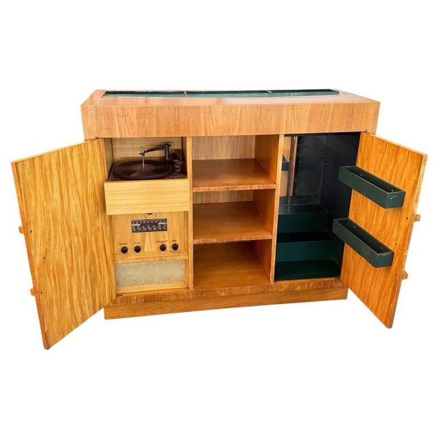 This striking Art Deco piece serves as a sophisticated, all-in-one entertainment center and bar. Crafted from bookmatched...