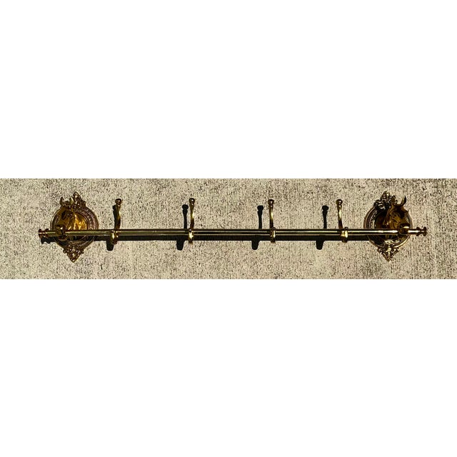 This stunning vintage coat rack is a masterclass in equestrian-inspired design, featuring two masterfully cast horse head...