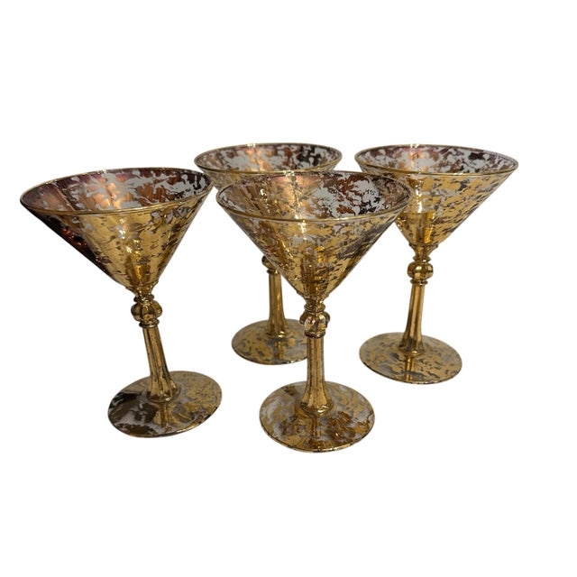 A set of 4 libbey “stardust” pattern martini glasses with metallic gold speckling or spatter.