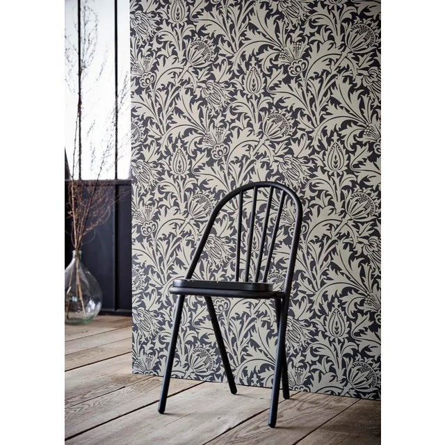 Over-sized simplified thistle heads framed by scrolling leaves adorn this all-over wallpaper echoing the neo-Gothic...