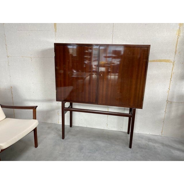 Ole wanscher rungstedlund two-door cabinet, p. Jeppesen, denmark, circa 1970 a refined example of danish modern design by...