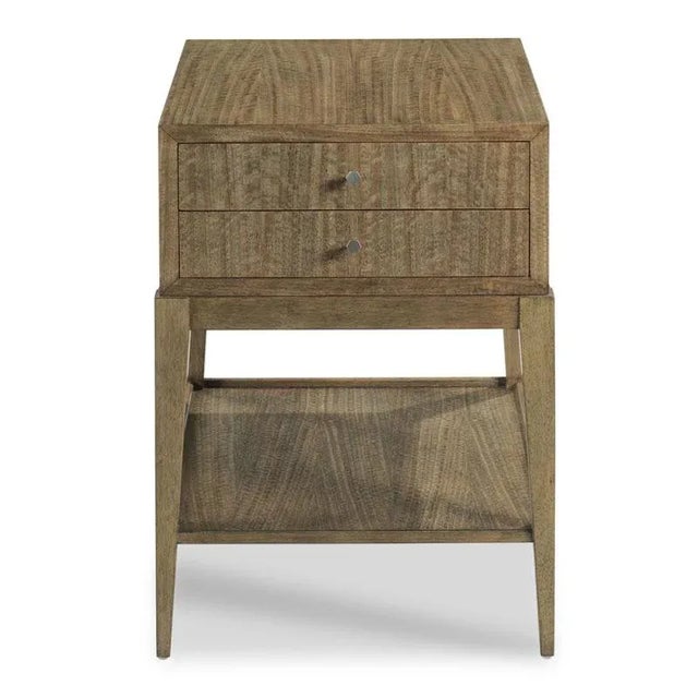 A versatile side table with a rectangular case featuring two drawers and four square tapered corner posts joined by a low...