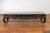 A Chinese Qing Dynasty period low Kang coffee table from the 19th century, with carved apron, mythical figures, auspicious...