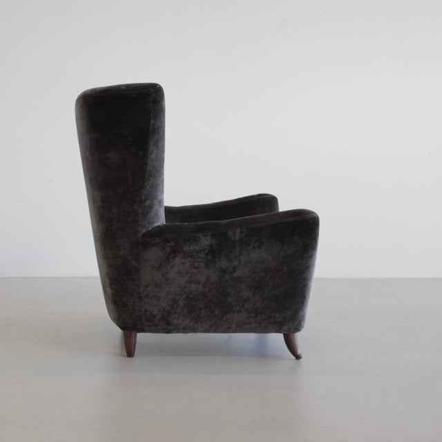Rare wingback lounge chair by Paolo Buffa, upholstered in recent dark chocolate brown velvet material. This armchair with...