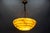 An Art Deco style marbled layered yellowish beige and brown glass and brass pendant light from the 1950s, Germany. This...