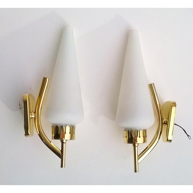 These two wall lights are attributed to Angelo Lelii for form and style. The seller guarantee the authenticity of items....