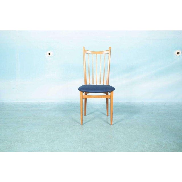 Beautiful organically shaped set of four identical dining room chairs made with beech wood and new blue upholstery of high...