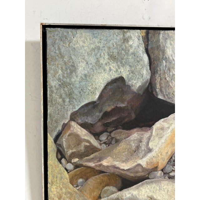 Hyperrealistic scene of a rocky beach grotto with pebbles and stones, oil on canvas, signed White, Rockport, MA, dated 1971.
