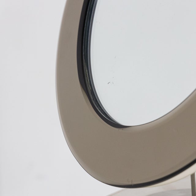 Adjustable freestanding mirror, Italian design and product from the 1970s. The frame is made of metal and glass with pink...