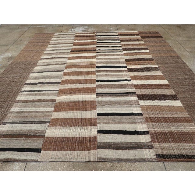 A Vintage Flatweave Kilim room size carpet handmade during the Mid-20th century. Measures: 12' 0" x 13' 1"