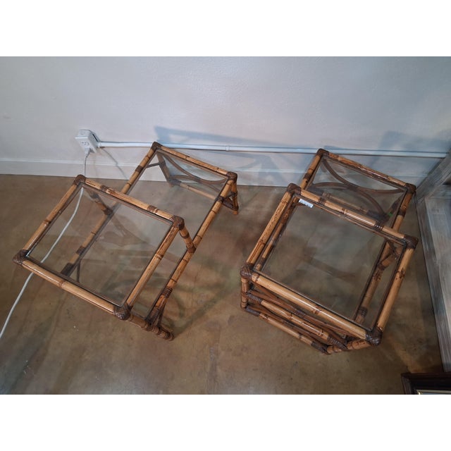 Vintage Pair of Bamboo & Rattan 2 Tiered Glass Top End Tables. This pair of vintage end tables features solid rattan...