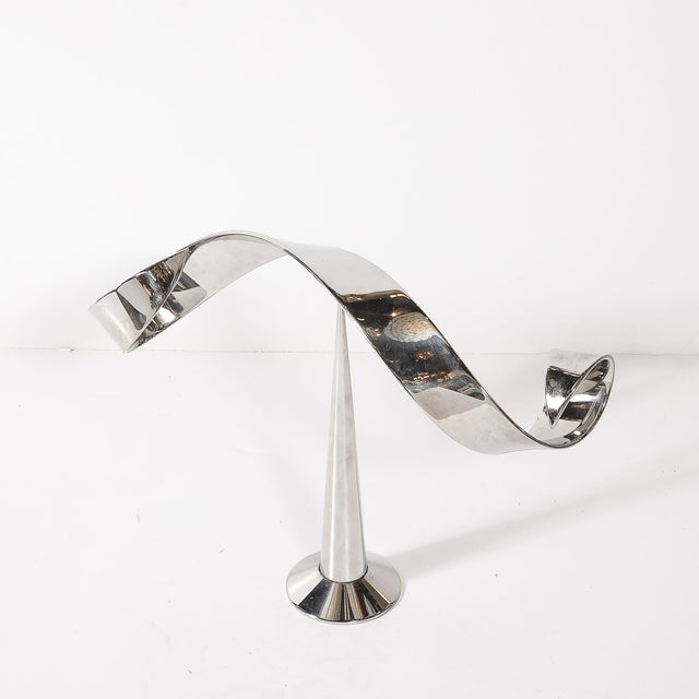 This Mid-Century Modernist chrome kinetic sculpture by Elijah David Herschler, created in the United States circa 1976, is...