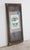Mac Cionaoit family coat of arms poster with a County Monaghan enamel crest in a vintage billboard display frame. The Mac...