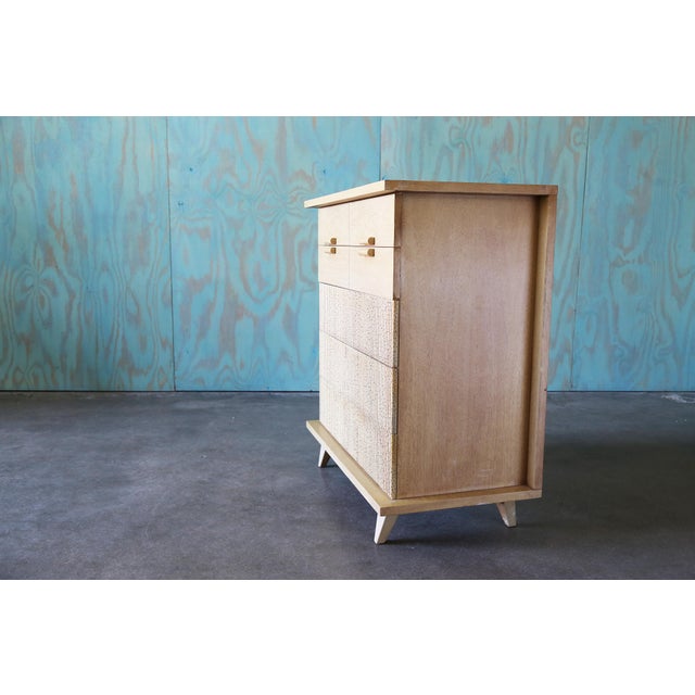 A tall cabinet designed by Merton Gershun for American of Martinsville in the 1950s. This piece from the Bali Hi series...