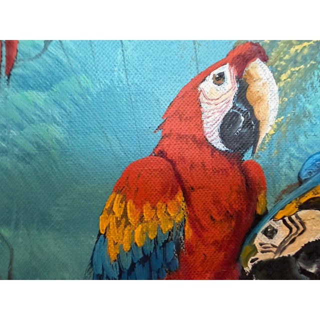 This vibrant vintage oil on canvas painting depicts two exotic parrots perched among lush tropical foliage overlooking a...