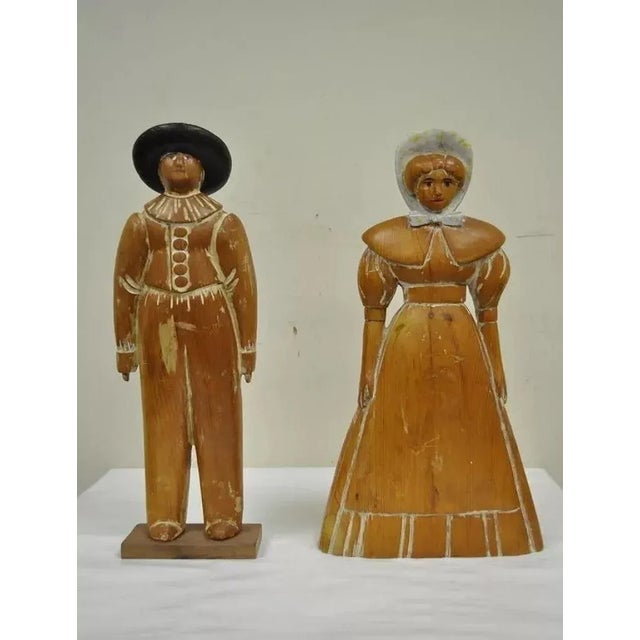 Vintage Sarreid Ltd Pine Wooden Folk Art Sculptures Man and Woman 22" Tall - a Pair. Item features a Huffman Koos label on...
