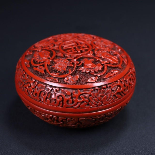 This beautifully carved round lidded box features classic Chinese cinnabar red lacquer detailing. The top surface is...