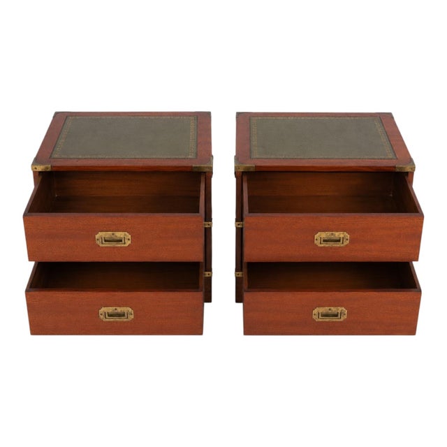 This is a pair of English mid-century mahogany campaign style side tables. The tops have tooled green leather, and the...
