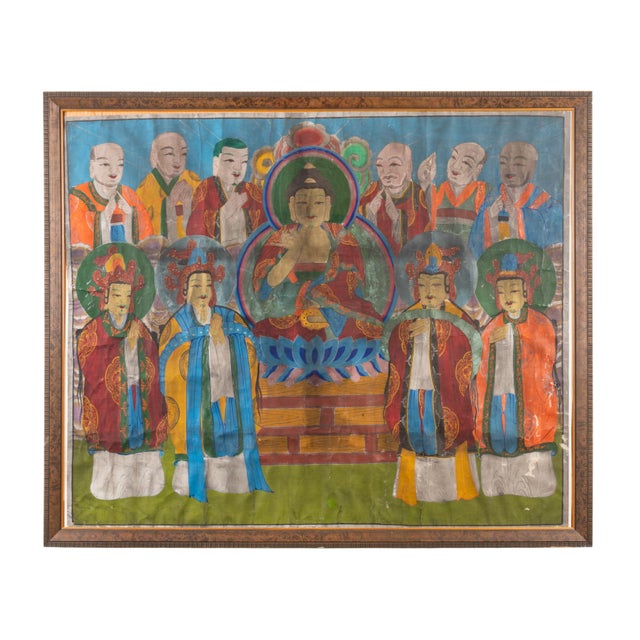 A striking antique Tibetan thangka painting depicting a central seated Buddha surrounded by ten attendant figures and...