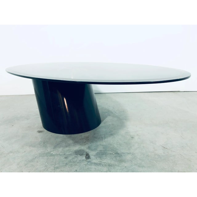 Black beveled glass with black lacquered wood base cantilevered coffee or cocktail table by Design Institute of America....