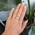 A 5.81-carat rainbow moonstone cabochon glows with a floating blue adularescence across this solid 14K yellow gold ring,...