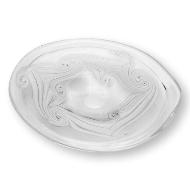 Handblown by American glass artist M. Rhys Williams, this vintage art glass bowl features swirling white ribboning in...