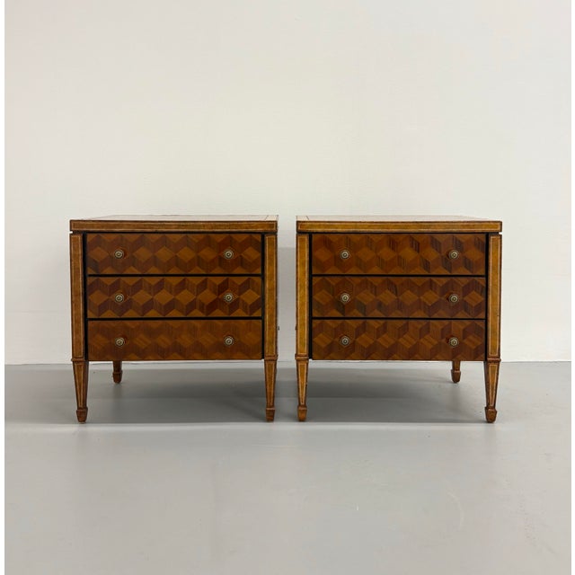An elegant pair of vintage Maitland-Smith bedside tables featuring striking geometric marquetry veneers in richly figured...