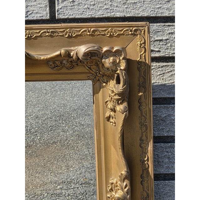 This product is a stunning 19th century gilded French decorative hand carved wall mirror. The mirror is framed in gold,...