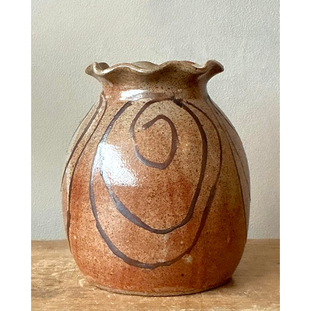 Introduce a touch of organic warmth and artistic whimsy to your decor with this charming vintage studio pottery vase....
