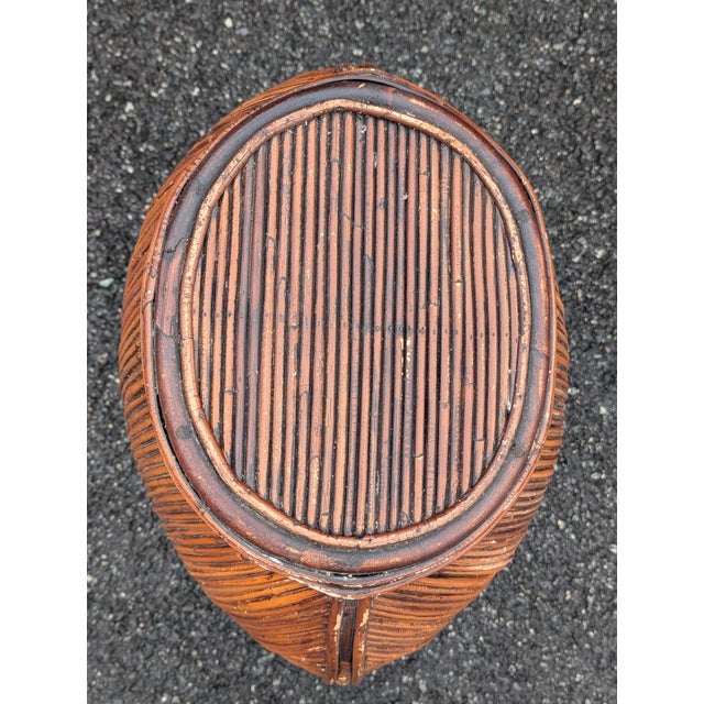 This vintage coastal monumental pencil reed lidded oval basket makes a striking, sculptural statement in any luxury...