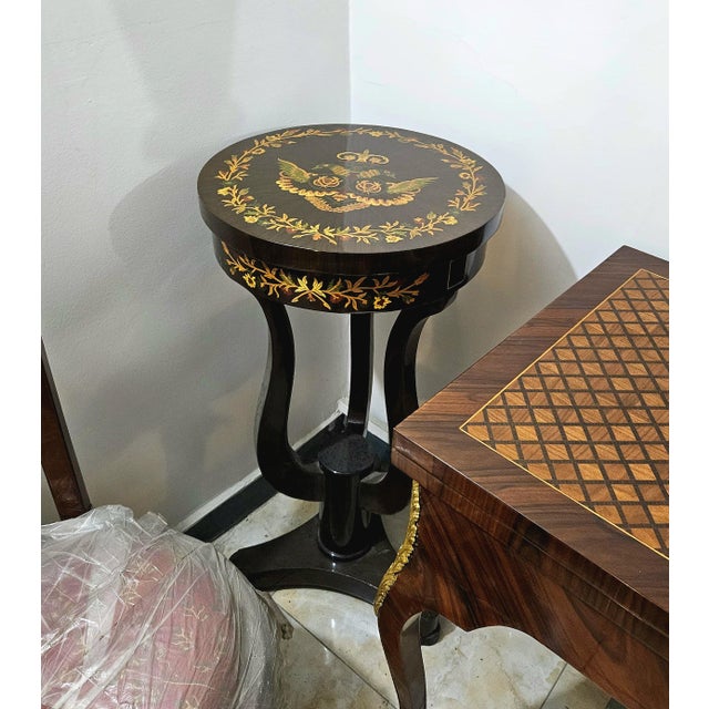 Add a sophisticated European accent to your interior with this French Louis XVI-inspired pedestal side table, featuring a...