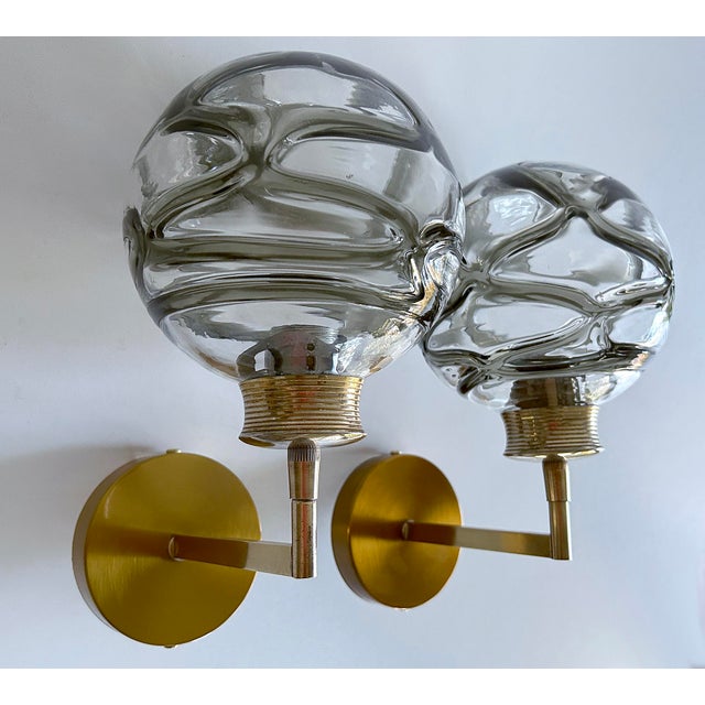 Pair of Vintage sconces by Doria 1970s, brass structure with structured cocoon Murano glass globes with dark sage green...