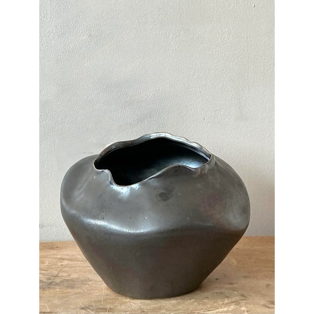 Immerse your space in the serene allure of this vintage Raku fired vase, a captivating piece that beautifully embodies a...