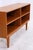Vintage teak shelving unit with four spacious open compartments and a clean, straight design. The compact frame stands on...