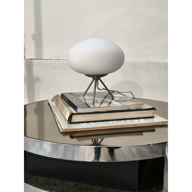 Beautiful Ifo table lamp. Italy, 1970s. Tripod base in silver-colored metal. It supports a very attractive diffuser globe...