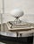 Beautiful Ifo table lamp. Italy, 1970s. Tripod base in silver-colored metal. It supports a very attractive diffuser globe...