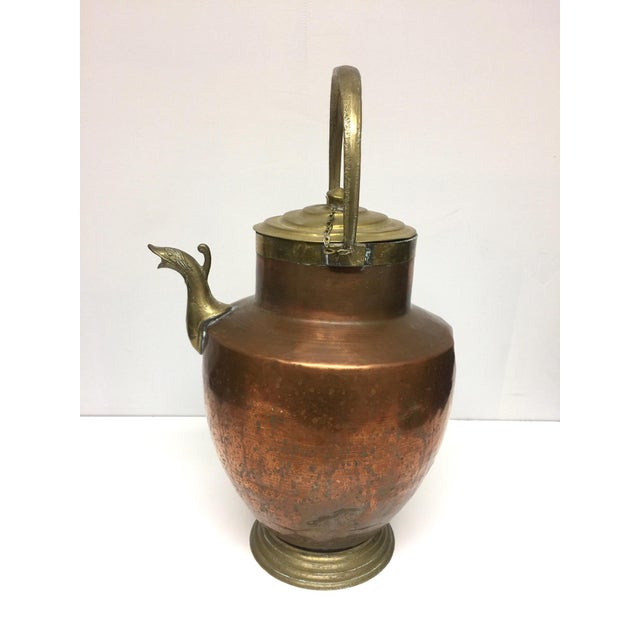 Antique French copper and brass jug, pitcher, watering can. This copper and brass vessel features a quail head spout. The...