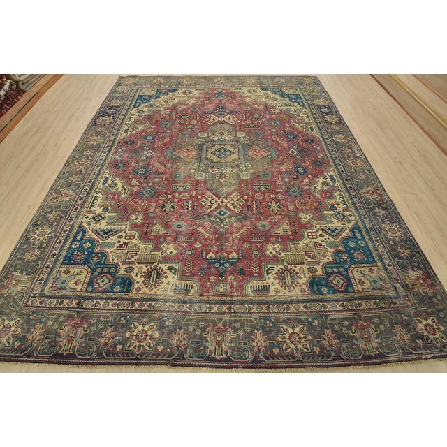 An authentic vintage traditional Tabriz rug hand-knotted with fine wool and natural dyes. This oriental rug features a...