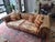Pair of vintage (likely 90’s) leather chesterfield style sofas with newly, professionally upholstered cushions and...