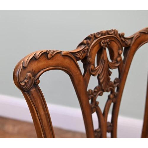 Handsome Chippendale style armchair with a tall back and elaborate pierced central splat. The shaped crest rail features...
