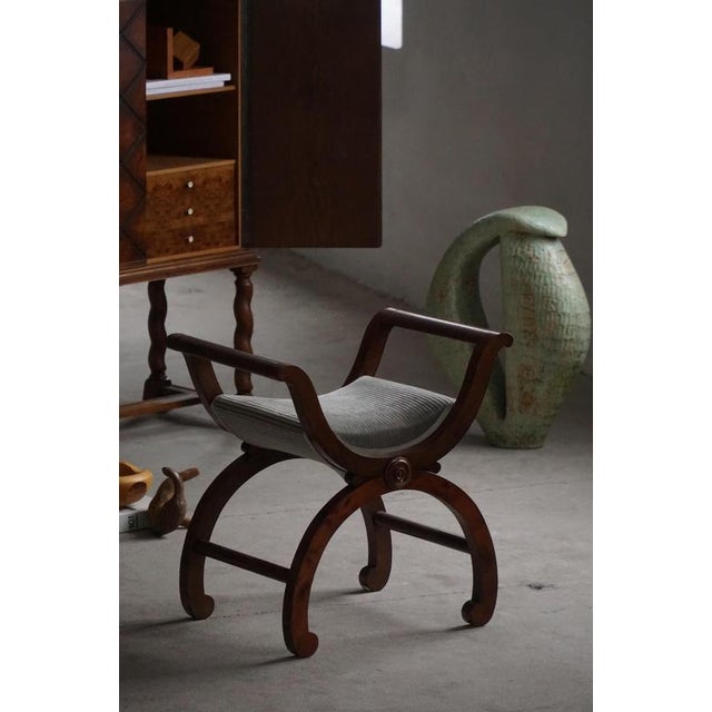This elegant piano chair, stool, or bench in the Empire style—is distinguished by its characteristic intersecting...