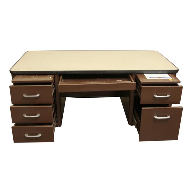 Mid Century steel tanker desk painted brown with a Formica tabletop, commonly used in schools and offices. The steel desk...
