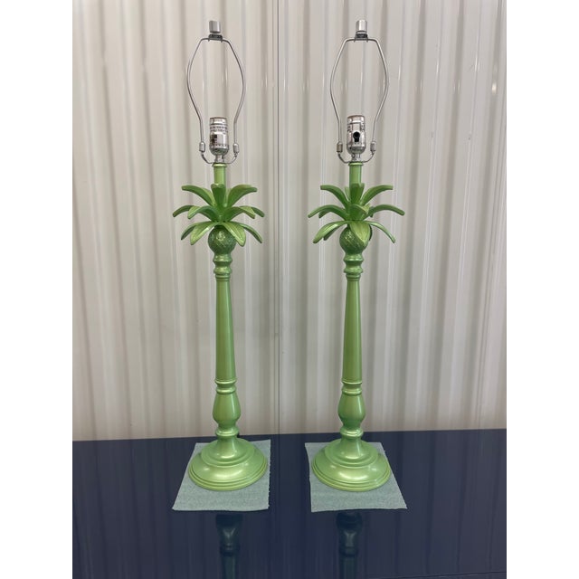 A fabulous pair of vintage palm tree table lamps newly refinished in a luminous metallic green lacquer. The subtle shimmer...