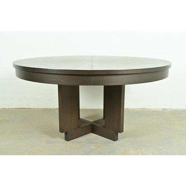A gorgeous Modern or contemporary style dark oak pedestal extension dining table with starburst top In the manner of...