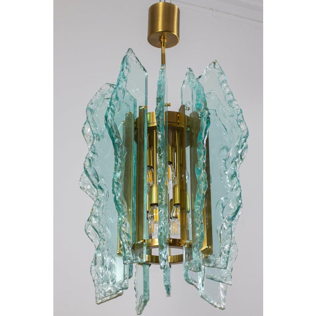 Amazing Mid - Century Fontana Arte chandelier. Chrome frame with precious green colored Hammered cut-glass. Available an...
