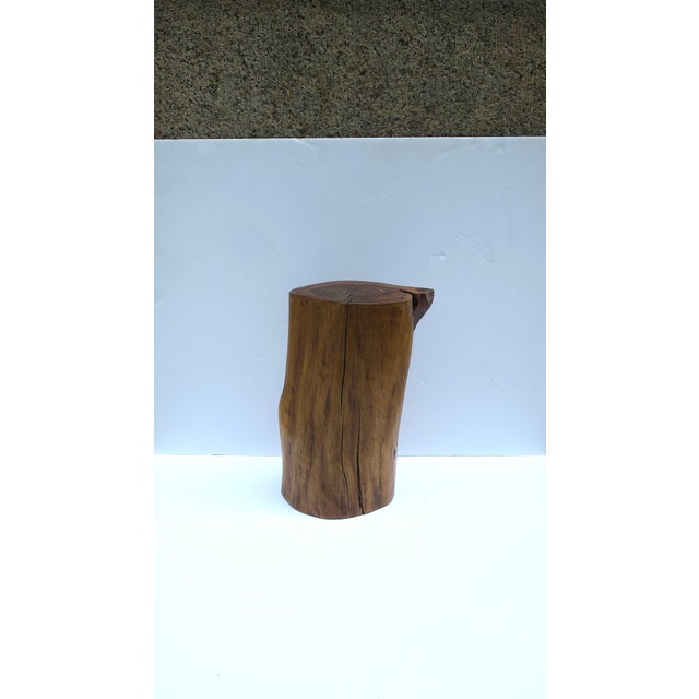 A natural wood pedestal side drinks table, in the Organic Modern style, circa late‑20th century. A rich natural brown wood...