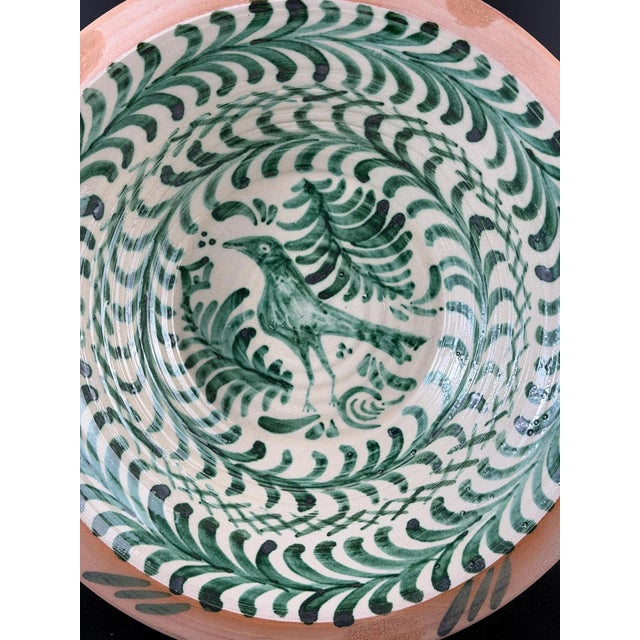 Large hand-painted lebrillo bowl from the Fajalauza tradition, produced in Granada, Spain Decorated with a central bird...